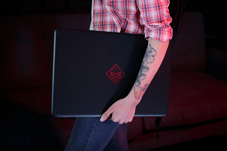 Gamer carrying her Omen by HP Notebook